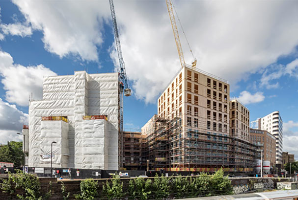 Two buildings under construction, on the right using cross laminated timber construction