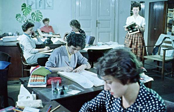 Five white women in an office setting undertaking administrative tasks in the 1960s