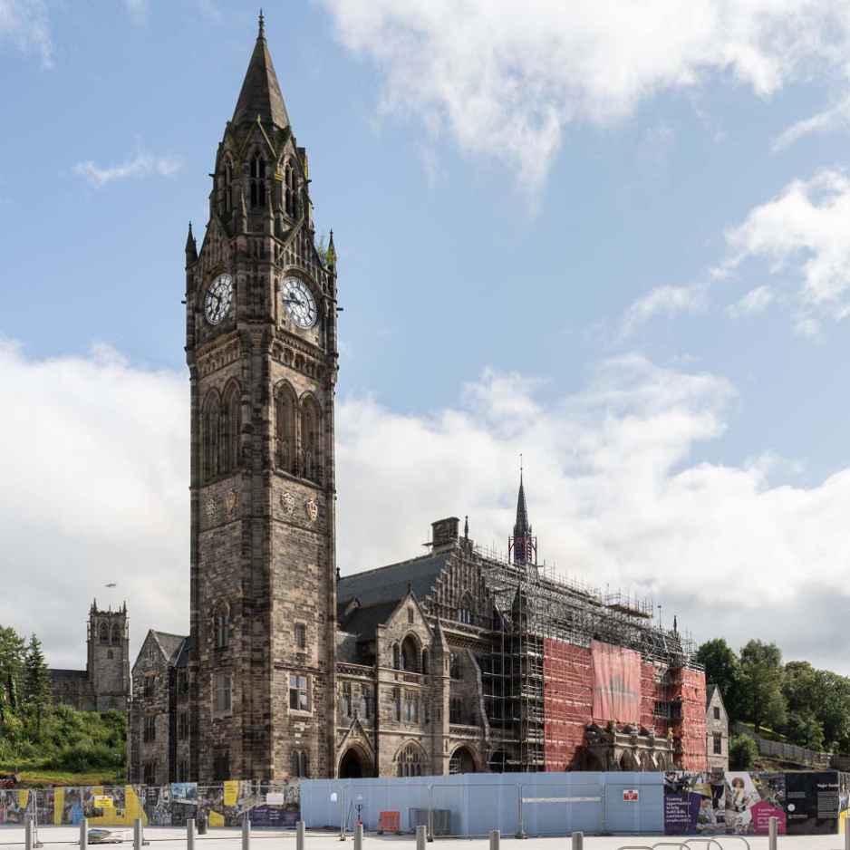 Victorian church with steeple, the hall is surrounded by scaffolding.