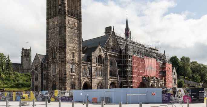 Victorian church with steeple, the hall is surrounded by scaffolding.