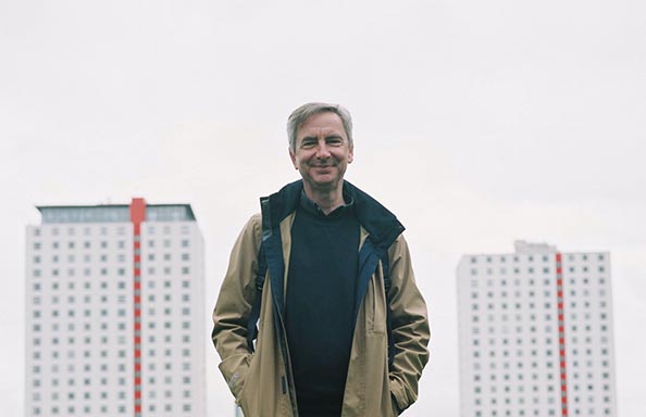 Dr John Boughton with the Pendleton Estate Salford behind him, Image Credit John Aitken