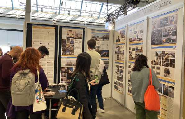 Inside an exhibition hall with people looking at tall exhibition display boards