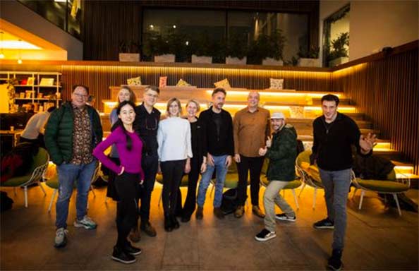 Group of people standing in a wood panelled foyer