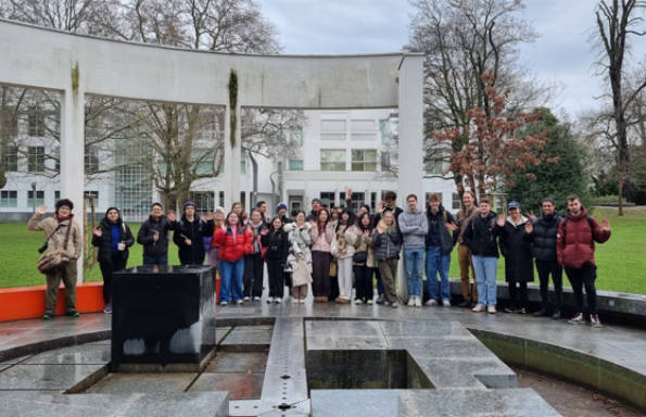 Group of students outside standing in the middle of a circular concrete structure.