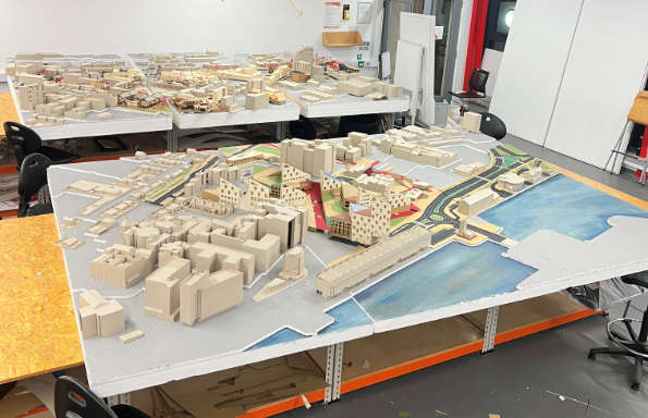 A large site model on display in a small room.
