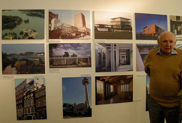 Gerald Beech standing in front of an exhibition of his work. Image kindly supplied by Charlotte Narula