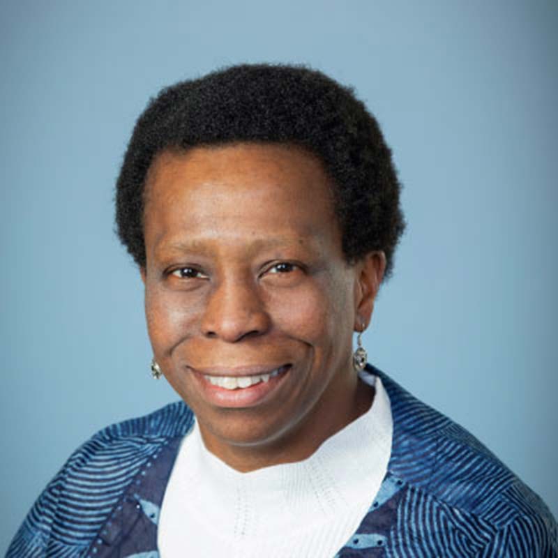 Professor Ola Unduku photographed against a pale blue background