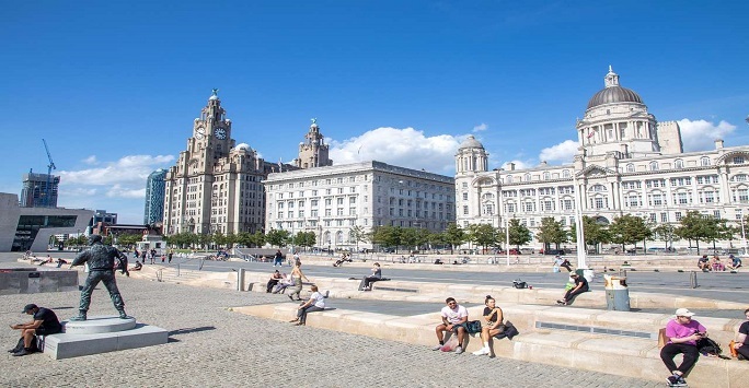 A photograph of Liverpools Pier Head with the Three Graces in the background