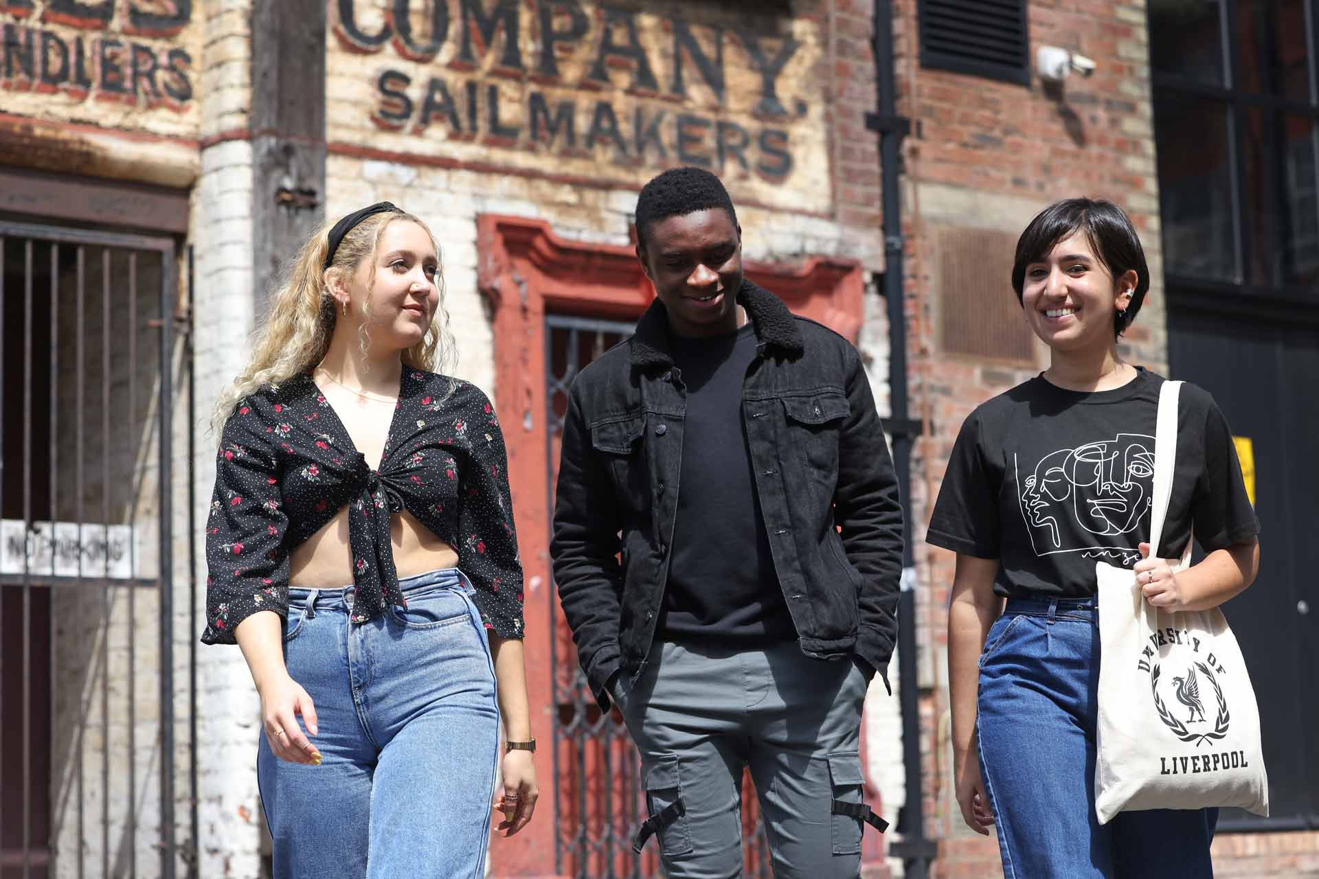 Three students walking on campus