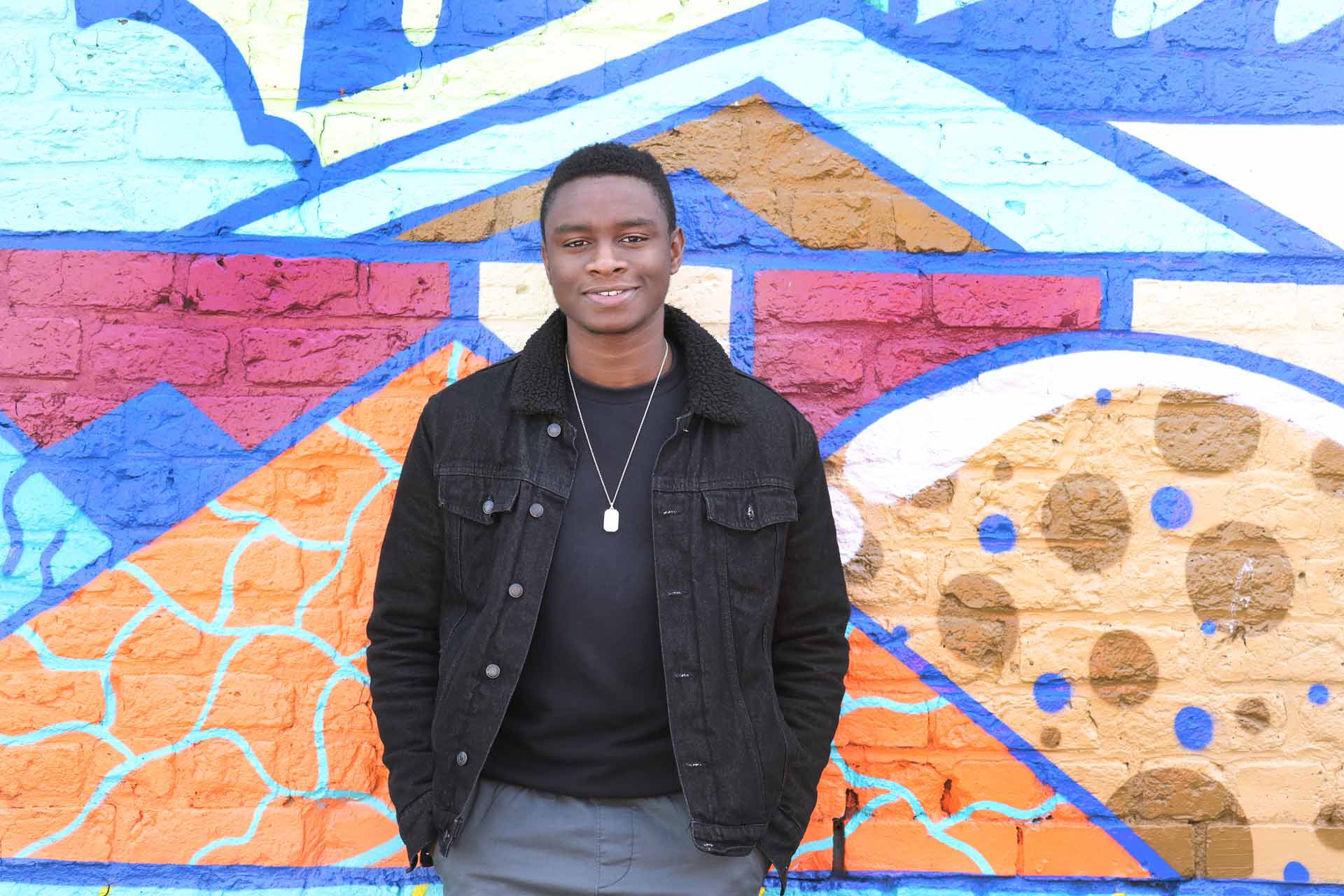 Student standing by a wall