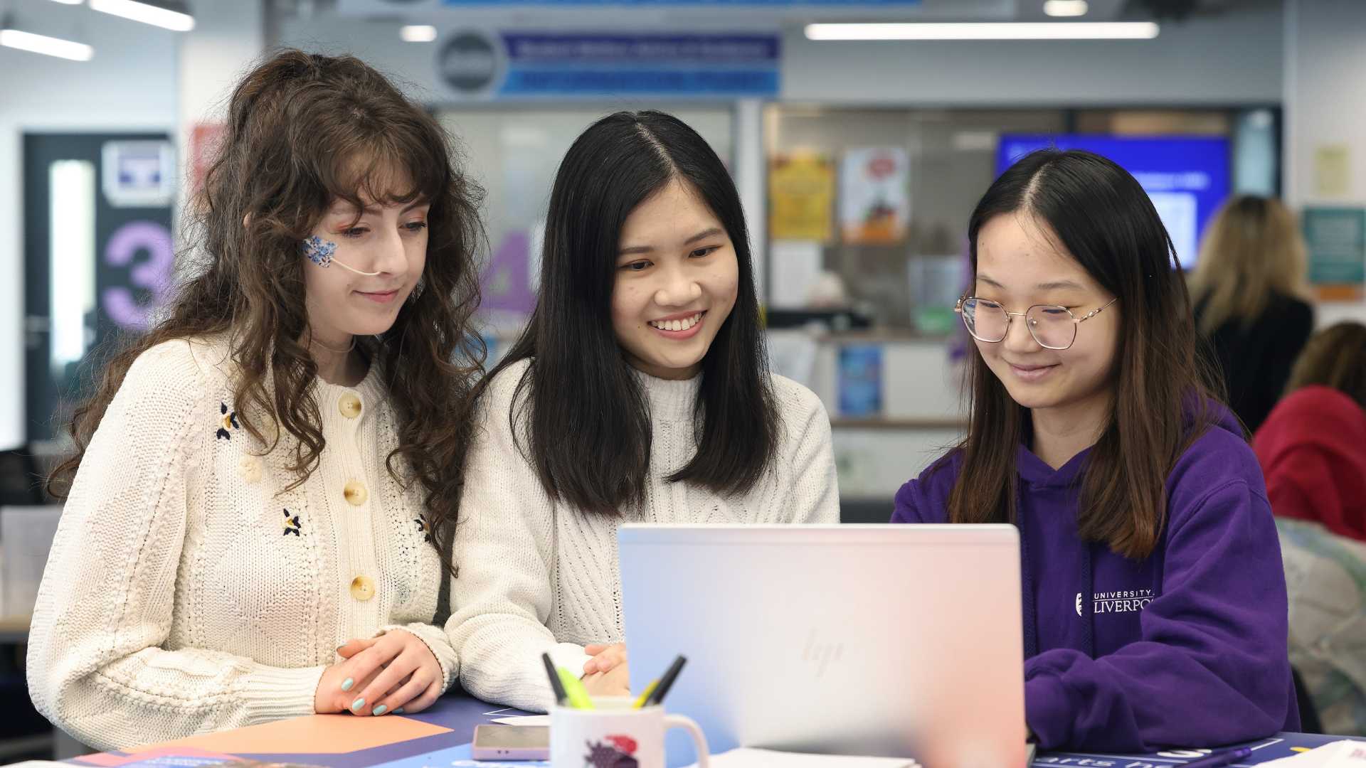 A Career Coach with two students looking at the PC