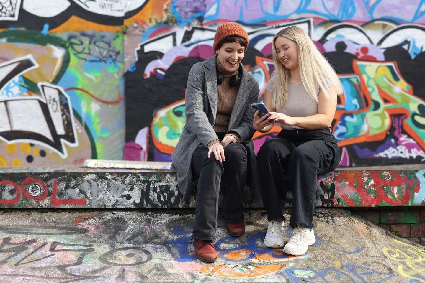 students in urban setting looking a phone
