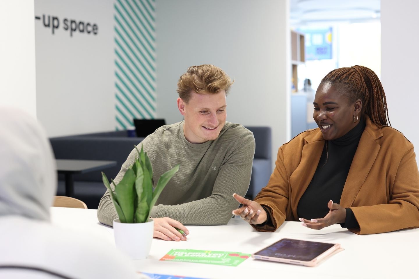 Young entrepreneurs brainstorming innovative ideas in a creative workspace, symbolising ambition, innovation, and enterprise in higher education.