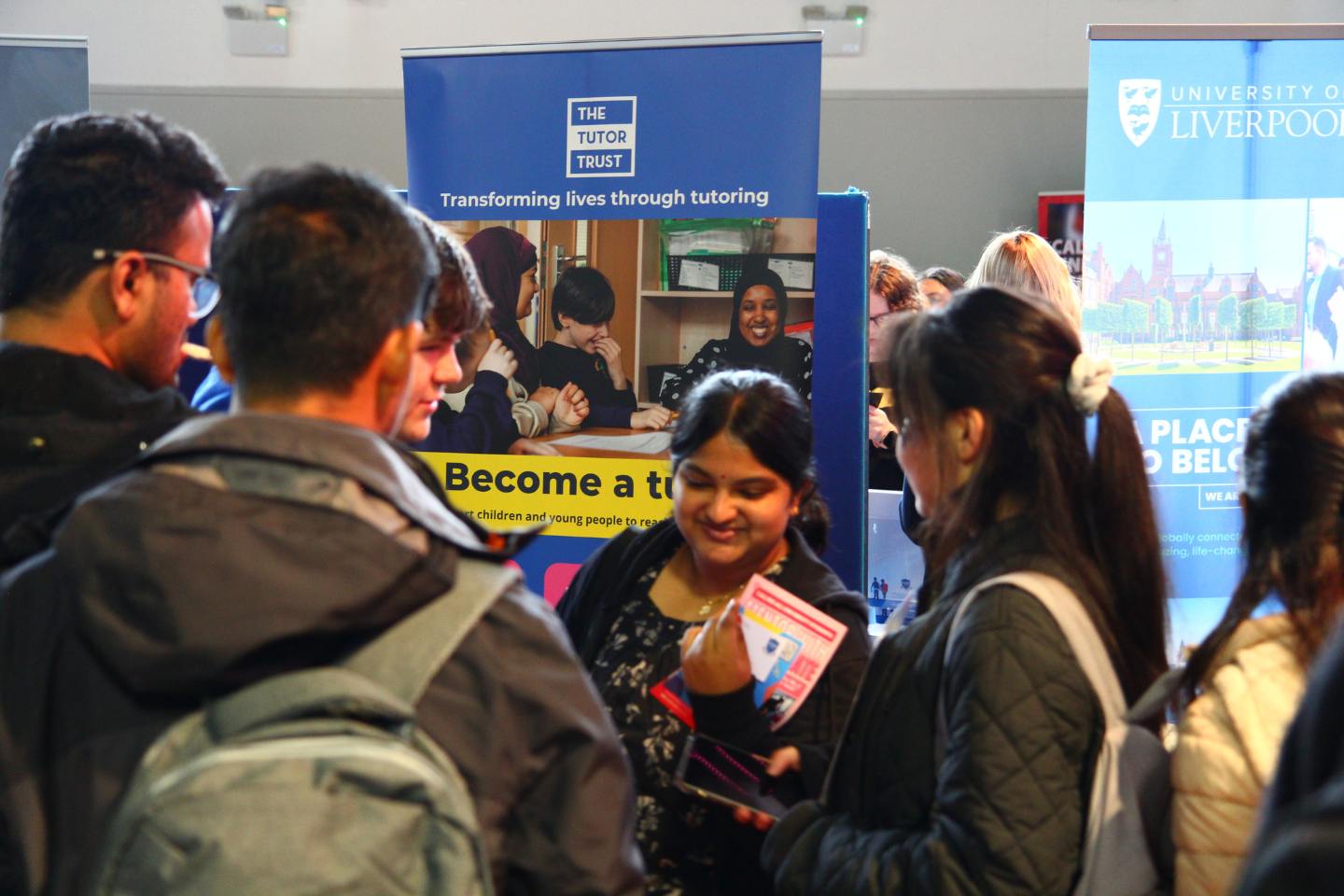 A group of international students speaking with employers at a career fair held at the University of Liverpool.