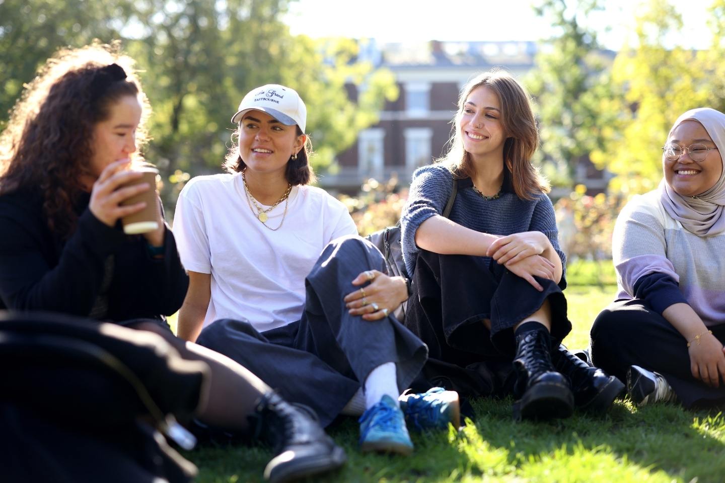 Students sitting on campus in a sunny day