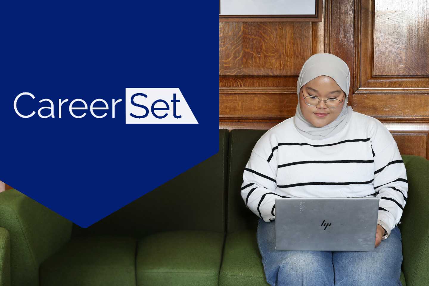 Student in the library looking at her laptop