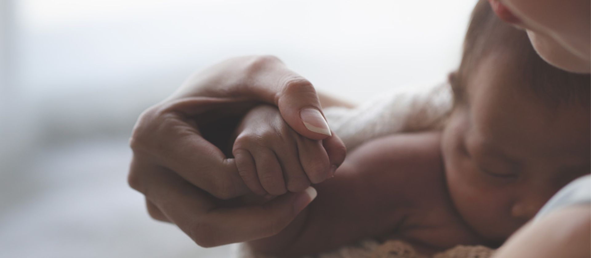 newborn held by mother