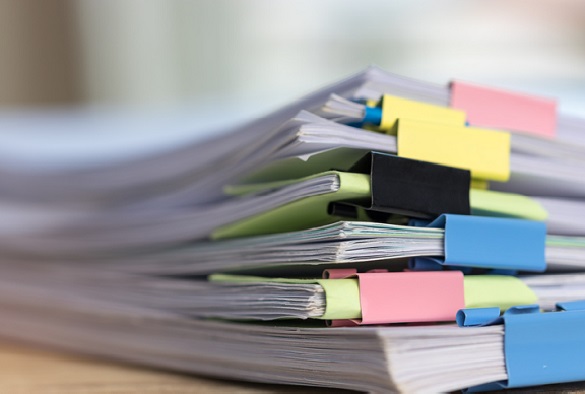 A stack of papers being held together with colourful clips