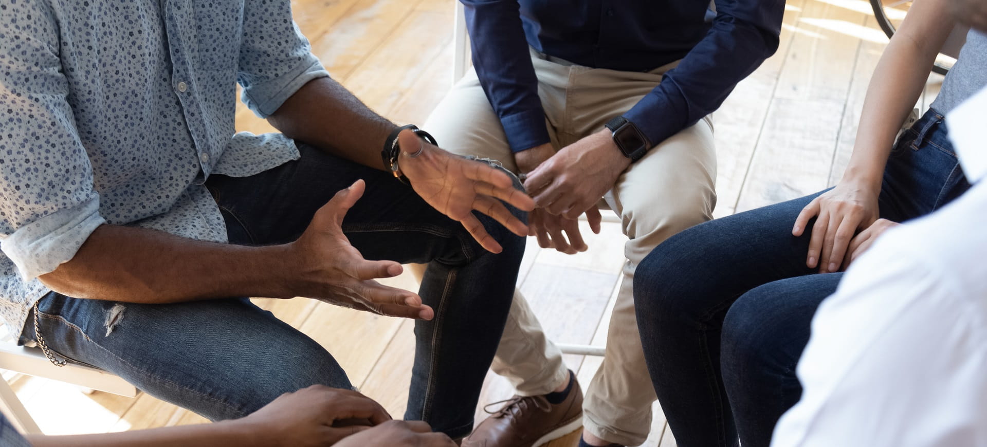A community group are sat in a close circle for a discussion