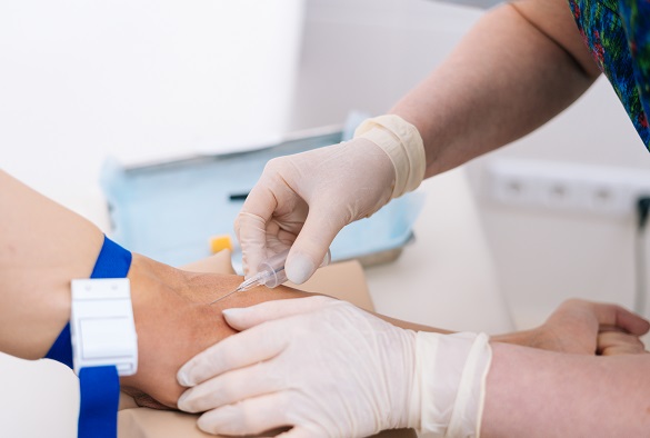 A nurse preps a patient arm for an injection