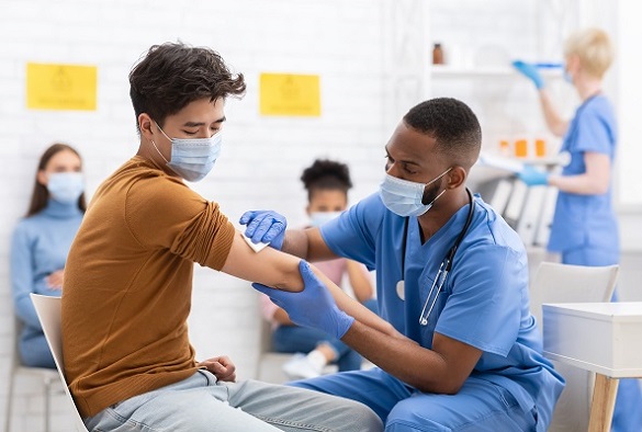 A nurse preps a patient arm for an injection