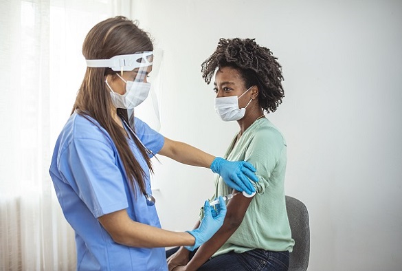 A nurse preps a patient arm for an injection