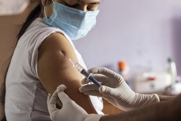 A nurse preps a patient arm for an injection