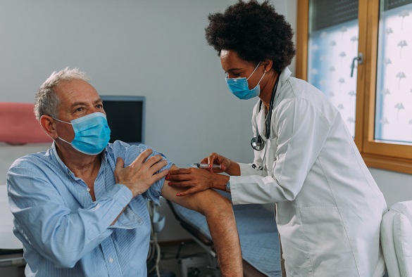 A nurse preps a patient arm for an injection