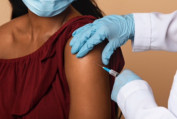 A nurse preps a patient arm for an injection