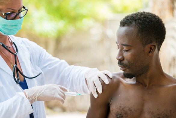 A nurse preps a patient arm for an injection