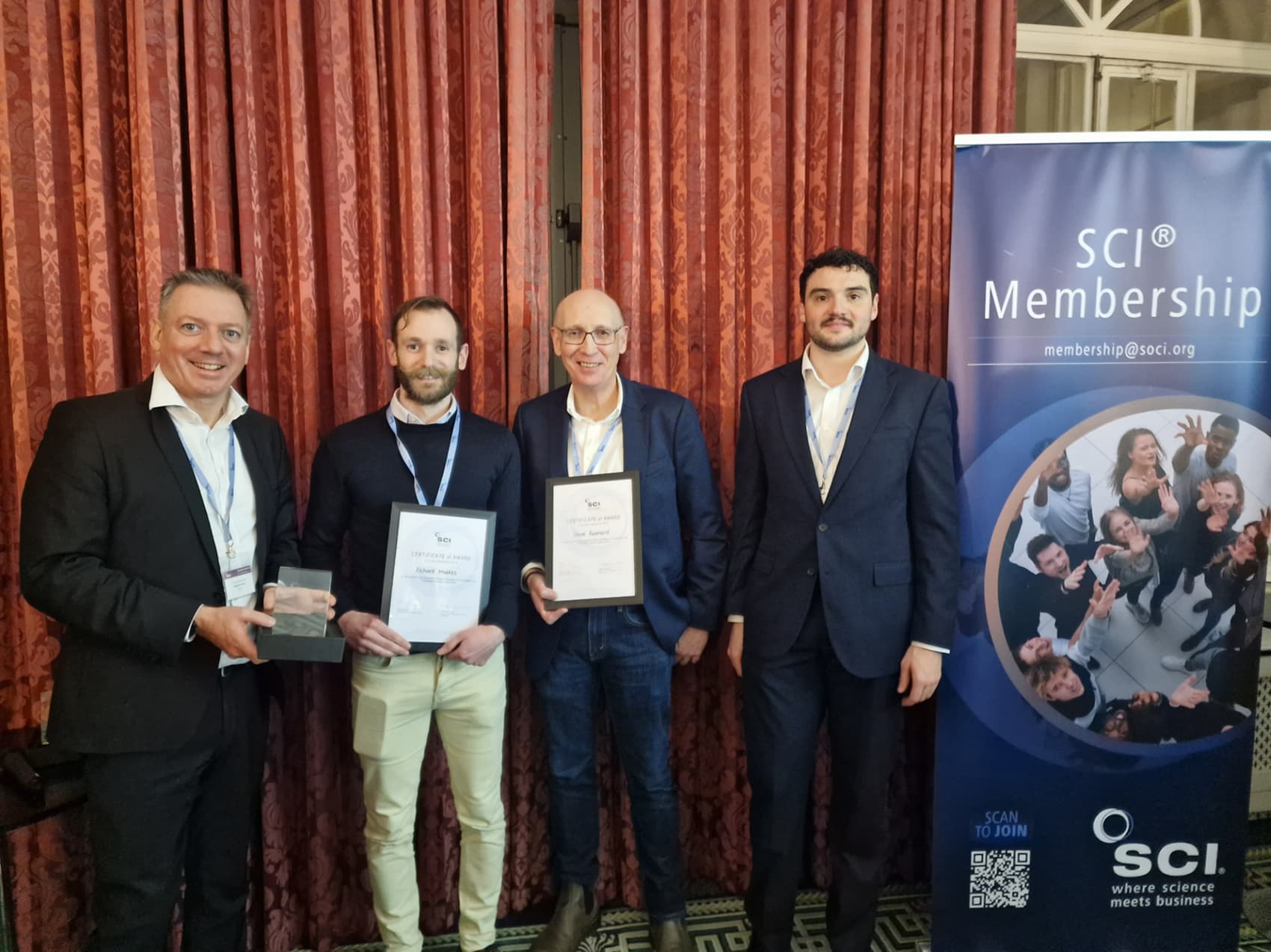 Professor Steve Rannard stands with other members of the SCI forum to receive the glass award