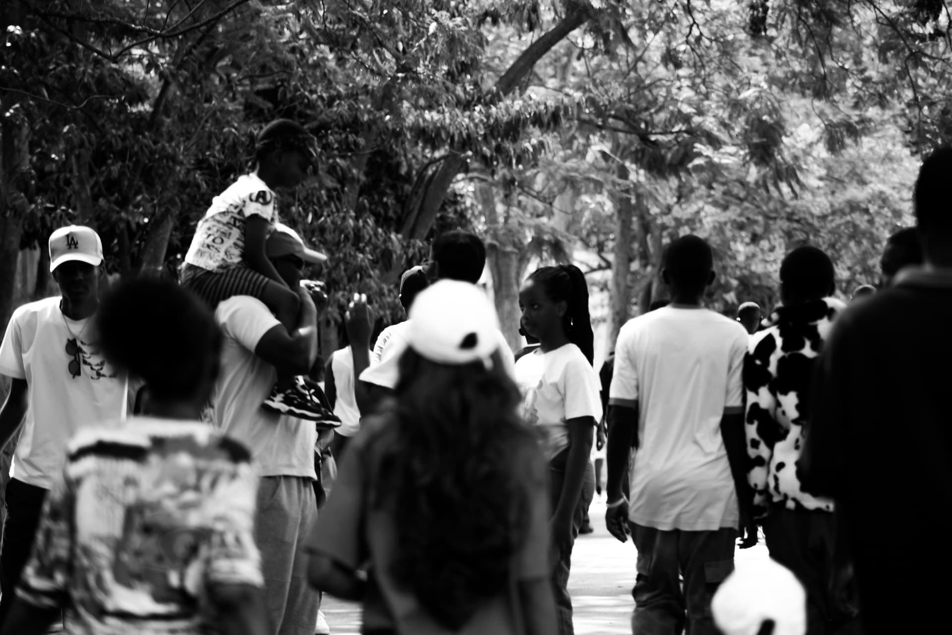 A large group of young people are walking around town in Rwanda