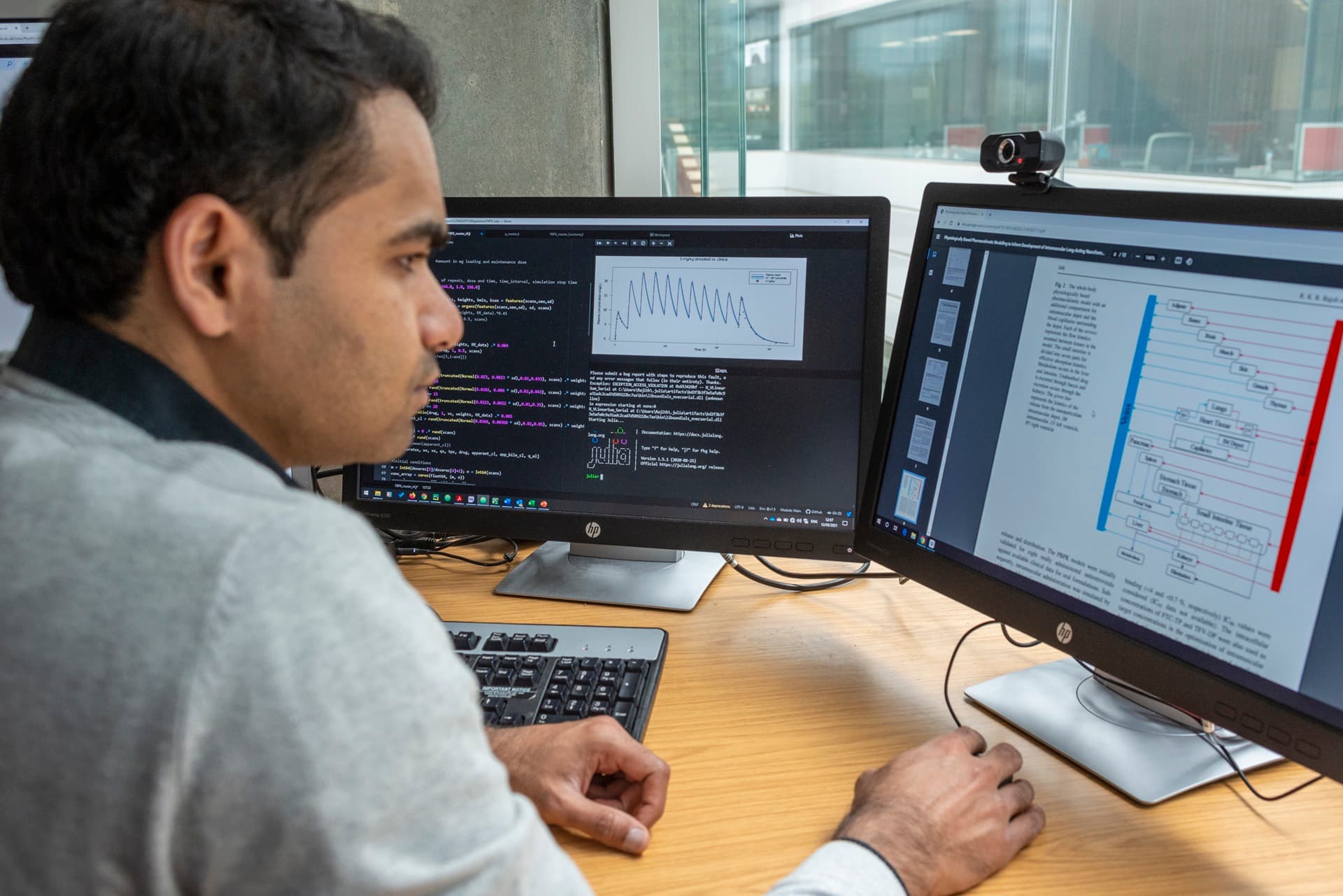 Dr Rajith Rajoli is sat at his computer working on some PBPK models