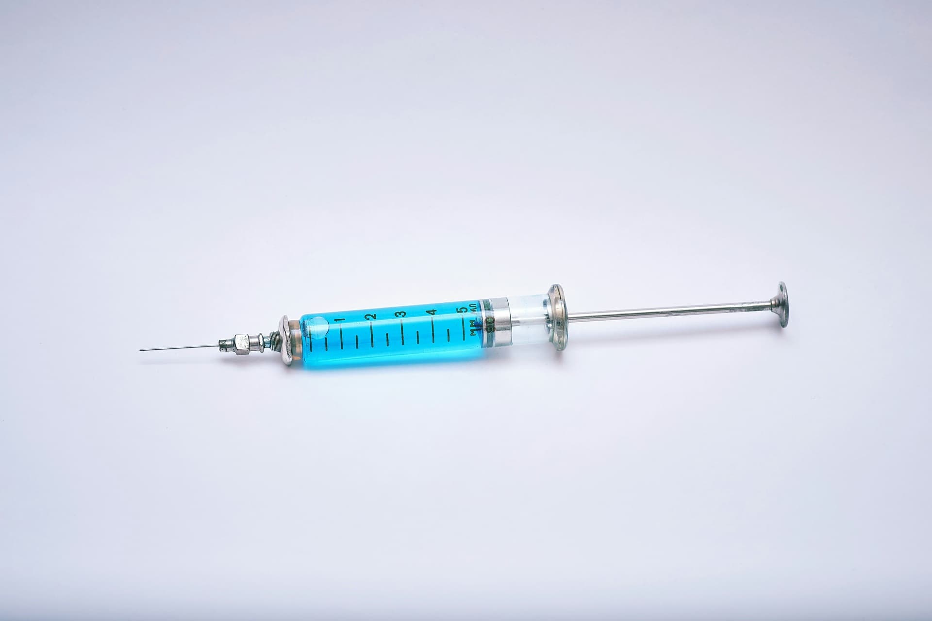 a syringe filled with light blue liquid