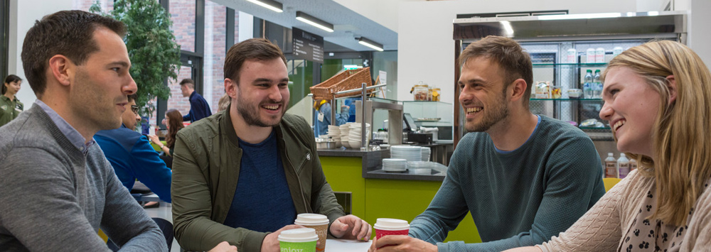 Students Talking at Coffee Shop Table