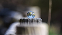 Glass ball on wooden surface