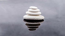 Pebbles stacked on top of each other on water