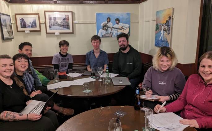 People sat around a table in a pub