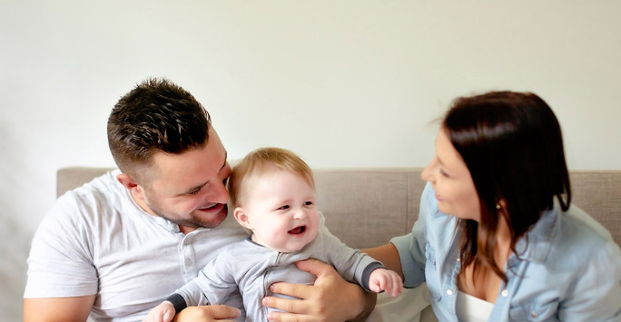 image of two adults with baby