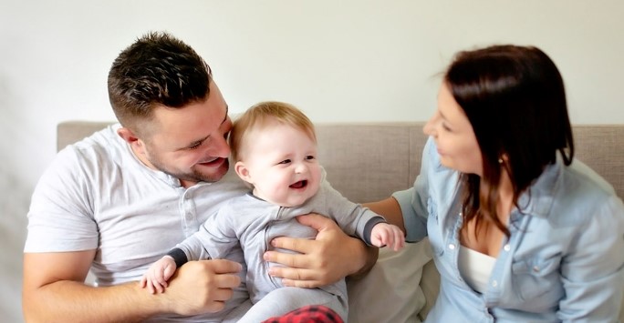 Stock image of a family sitting on a sofa