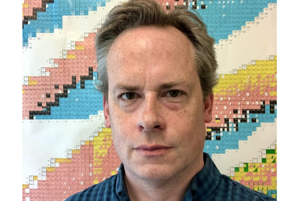 BradleyCheal headshot in front of a vibrant, multicolored wall