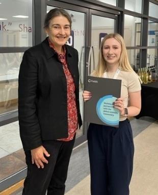 A photo of Lucy Walters being awarded her poster prize