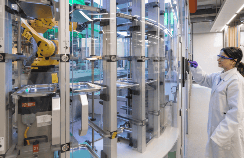 Scientist in a lab controlling a robot