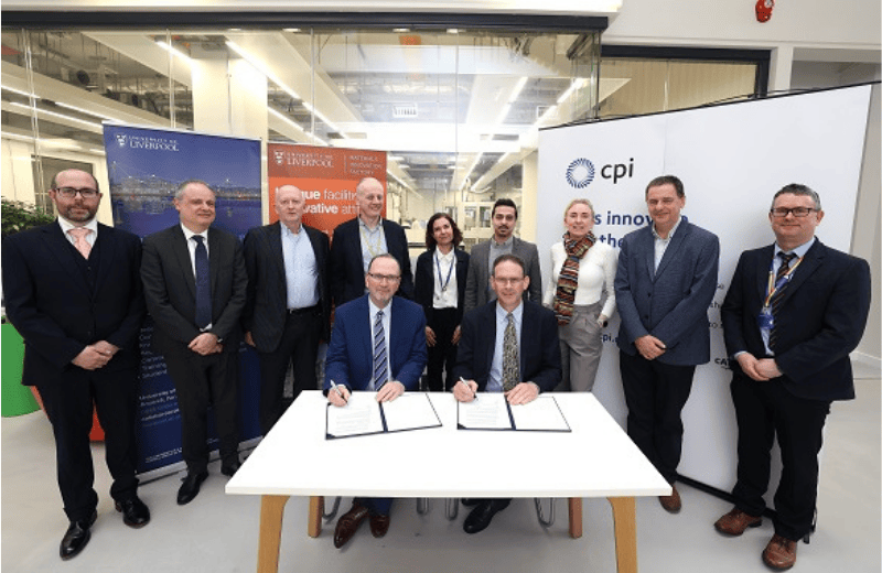 Univeristy staff in the Materials Innovation Factory signing an MoU