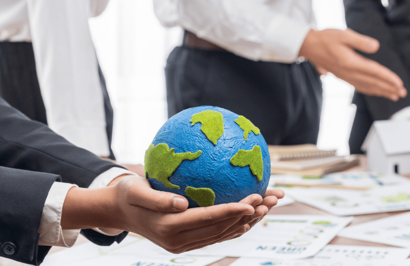 Stock image of a business person in a suit holiday a globe in their hands