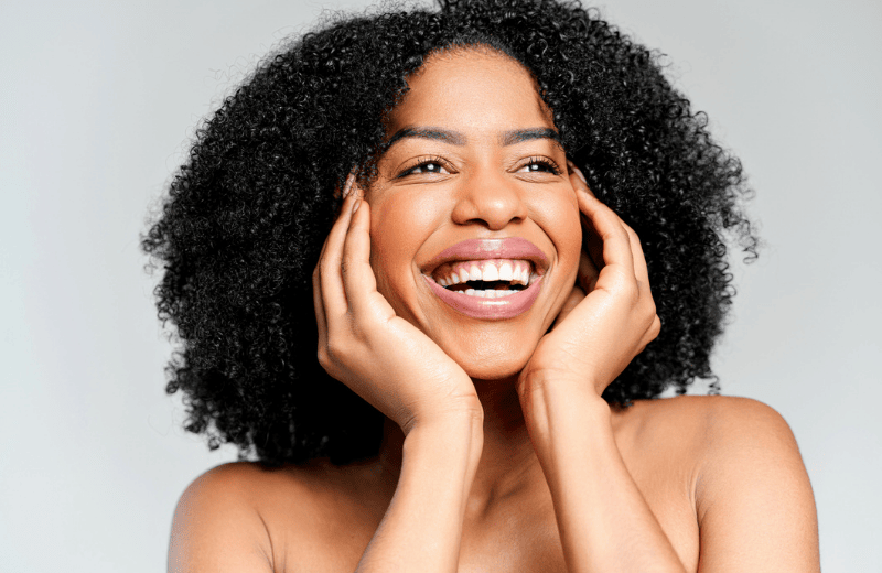Photo of a model smiling with clear skin