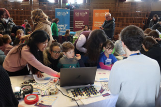 Demonstrator showing public how to program robots