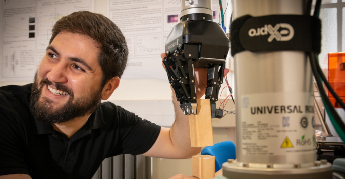 PhD Student using robotics equipment