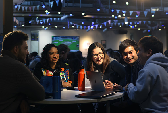 Group of students at a table laughing together