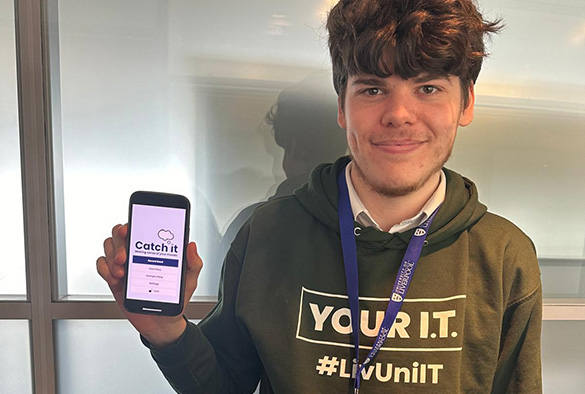 Graduate developer holding phone open to their Catch It app